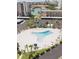 Aerial view of a triangular shaped pool with palm trees, lounge chairs, and parking nearby at 7465 Bay Island S Dr # 312, South Pasadena, FL 33707