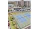 Aerial view of community tennis courts near the building with covered parking spaces at 7465 Bay Island S Dr # 312, South Pasadena, FL 33707