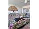 Cozy bedroom with floral patterned bedding, mirrors and a decorative hand fan, adding a unique touch at 7465 Bay Island S Dr # 312, South Pasadena, FL 33707