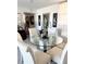 Elegant dining area featuring a glass table, comfortable chairs, and sophisticated decor, ideal for entertaining guests at 7465 Bay Island S Dr # 312, South Pasadena, FL 33707