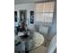 Charming dining area with a glass table, decorative art, and a window with sheer curtains at 7465 Bay Island S Dr # 312, South Pasadena, FL 33707