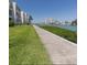 Exterior view showing a grass and waterside path near building and waterfront views at 7465 Bay Island S Dr # 312, South Pasadena, FL 33707