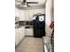 Well-lit kitchen with modern appliances and sleek black refrigerator offering functionality and style at 7465 Bay Island S Dr # 312, South Pasadena, FL 33707