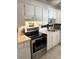 Bright kitchen featuring stainless steel appliances, white cabinets, and ample counter space for cooking and storage at 7465 Bay Island S Dr # 312, South Pasadena, FL 33707