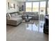 Spacious living room with large windows showcasing water views, comfortable seating, and stylish decor at 7465 Bay Island S Dr # 312, South Pasadena, FL 33707