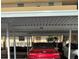 Assigned covered parking space for residents with a red car parked at 7465 Bay Island S Dr # 312, South Pasadena, FL 33707