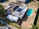 Aerial view of a home showcasing a pool, solar panels, a camper, and fenced yard at 8039 83Rd N St, Seminole, FL 33777