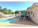 Relaxing backyard area featuring a sparkling pool, patio with an umbrella, and lush landscaping at 8039 83Rd N St, Seminole, FL 33777
