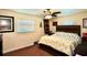 Comfortable bedroom with a wooden headboard bed frame, ceiling fan, and natural light at 8039 83Rd N St, Seminole, FL 33777