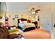 Spacious bedroom featuring a ceiling fan, closet, bed, and comfortable seating area at 8039 83Rd N St, Seminole, FL 33777