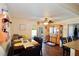 Bright dining area with a long dark wood table, seating for six, and a ceiling fan at 8039 83Rd N St, Seminole, FL 33777