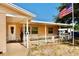 Inviting front porch featuring neutral colors, a decorative wreath, and patriotic decor at 8039 83Rd N St, Seminole, FL 33777