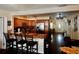 Open floor plan featuring a kitchen with wood cabinets, a breakfast bar, and dark wood floors at 8039 83Rd N St, Seminole, FL 33777