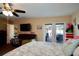 Main bedroom with ceiling fan, comfortable seating area, and access to the outdoor patio at 8039 83Rd N St, Seminole, FL 33777