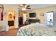 Bright main bedroom offers a ceiling fan, a bathroom, and a comfortable seating area at 8039 83Rd N St, Seminole, FL 33777