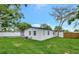 This backyard has a lush green lawn with ample space, complemented by a white privacy fence at 918 Skyview Dr, Brandon, FL 33510
