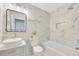 Bathroom with marble tile, decorative mirror, and modern sink at 918 Skyview Dr, Brandon, FL 33510