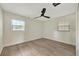 This bedroom has a ceiling fan, two windows, and wood flooring at 918 Skyview Dr, Brandon, FL 33510