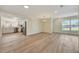 Open dining area with light wood floors, providing a spacious and versatile area for entertaining at 918 Skyview Dr, Brandon, FL 33510