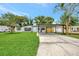 Charming home with a carport, lush lawn, and attractive landscaping, showcasing curb appeal at 918 Skyview Dr, Brandon, FL 33510