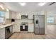 Bright kitchen features stainless steel appliances, white cabinets, subway tile backsplash, and wood flooring at 918 Skyview Dr, Brandon, FL 33510