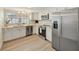 Well-lit kitchen featuring stainless steel appliances and white cabinetry, offering a clean and modern cooking space at 918 Skyview Dr, Brandon, FL 33510