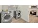 Well-equipped laundry room featuring modern washer and dryer appliances next to the kitchen at 918 Skyview Dr, Brandon, FL 33510