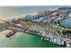 Picturesque aerial view of the beach, pier, boat docks, and buildings along the coast at 94 Devon Dr, Clearwater Beach, FL 33767