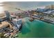 Aerial view of the waterfront with buildings, sandy beach, pier and boats on the water at 94 Devon Dr, Clearwater Beach, FL 33767