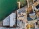 Aerial view of a waterfront home with a private dock and lush landscaping at 94 Devon Dr, Clearwater Beach, FL 33767