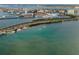 Scenic aerial view showcases a bridge and waterway surrounded by lush greenery and coastal scenery at 94 Devon Dr, Clearwater Beach, FL 33767