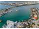 Scenic aerial view showcasing waterfront homes, docks, and boats nestled in a vibrant coastal community at 94 Devon Dr, Clearwater Beach, FL 33767