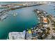 Aerial view showcases waterfront homes with private boat docks and serene waterway in the background at 94 Devon Dr, Clearwater Beach, FL 33767