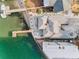 An aerial view captures a well-maintained home with waterfront access and a private boat dock at 94 Devon Dr, Clearwater Beach, FL 33767