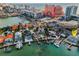 Beautiful aerial view of waterfront homes with boat docks, pools and neighborhood in the background at 94 Devon Dr, Clearwater Beach, FL 33767
