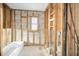 Bathroom renovation project with window, showing framed walls and plumbing for remodel at 94 Devon Dr, Clearwater Beach, FL 33767