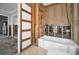 Bathroom renovation project with framed walls, new bathtub, and toilet installation area at 94 Devon Dr, Clearwater Beach, FL 33767