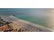 Stunning beach view with umbrellas, turquoise water, palm trees, and ocean views at 94 Devon Dr, Clearwater Beach, FL 33767