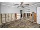 Spacious bedroom with ceiling fan and views to other rooms, ready for renovation at 94 Devon Dr, Clearwater Beach, FL 33767