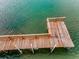 Private dock extends into the tranquil water, perfect for boating and enjoying waterfront living at 94 Devon Dr, Clearwater Beach, FL 33767