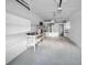 Spacious garage features bright white walls, ample shelving, and convenient access to the home's interior at 94 Devon Dr, Clearwater Beach, FL 33767