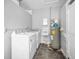 Functional laundry area with washer, dryer, and sink, ready for updates at 94 Devon Dr, Clearwater Beach, FL 33767
