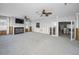 Large living room featuring a fireplace, ceiling fans, and a doorway to another room at 94 Devon Dr, Clearwater Beach, FL 33767