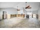 Bright and open living area, perfect for renovation, showcasing ceiling fans and spaciousness at 94 Devon Dr, Clearwater Beach, FL 33767