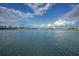 Expansive waterfront view with a city skyline under a blue sky filled with fluffy white clouds at 94 Devon Dr, Clearwater Beach, FL 33767
