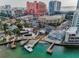 Beautiful waterfront view featuring private docks, boats, and an inviting in-ground pool at 94 Devon Dr, Clearwater Beach, FL 33767