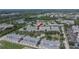 Aerial view of a community with townhomes, trees, and a pond at 9506 Harpender Way, Tampa, FL 33626