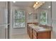Bright bathroom features a double sink vanity with a large mirror and a bright window at 9506 Harpender Way, Tampa, FL 33626