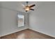 Bright bedroom with wood-look flooring, a ceiling fan, and a window with blinds at 9506 Harpender Way, Tampa, FL 33626