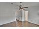 Bedroom featuring wood-look flooring, a ceiling fan, and doorways to other rooms at 9506 Harpender Way, Tampa, FL 33626